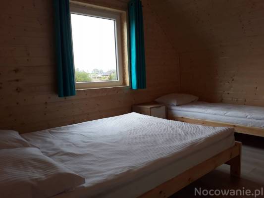 Zdjęcie przedstawia łoże w pokoju - Bałtyckie Zacisze | Sarbinowo (wypoczywaj nad morzem) 