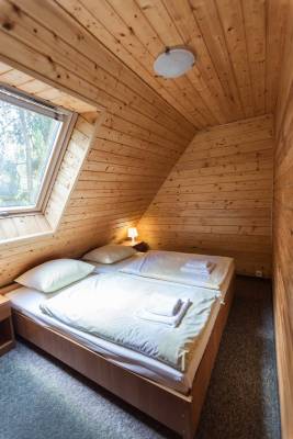Fotografia przedstawia łóżko w domku letniskowym ANGELA | apartamenty -  domki - pokoje