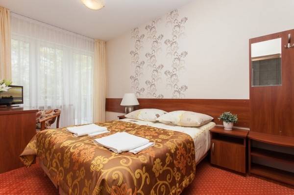 Ośrodek Wypoczynkowy Domki i Pokoje BOSMAN w Rewalu - zdjęcie łóżka małżeńskiego